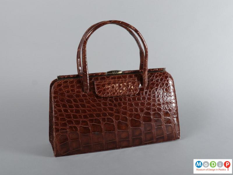 Front view of a handbag showing the texture of the skin.