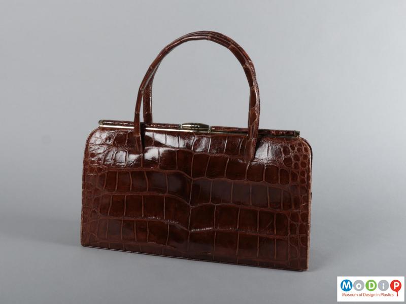Side view of a handbag showing the texture of the skin.