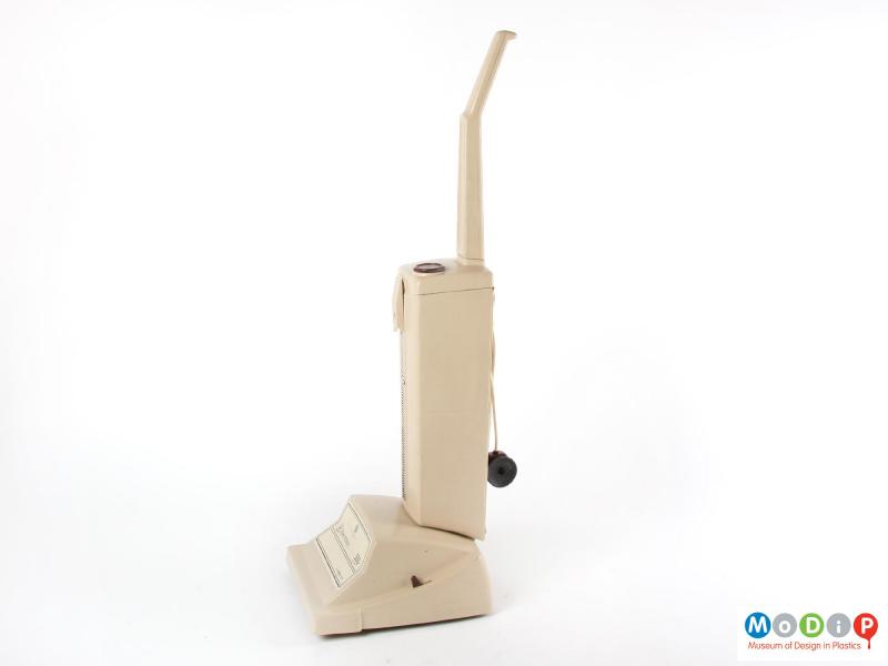 Side view of a toy vacuum cleaner showing the shape of the body and handle.