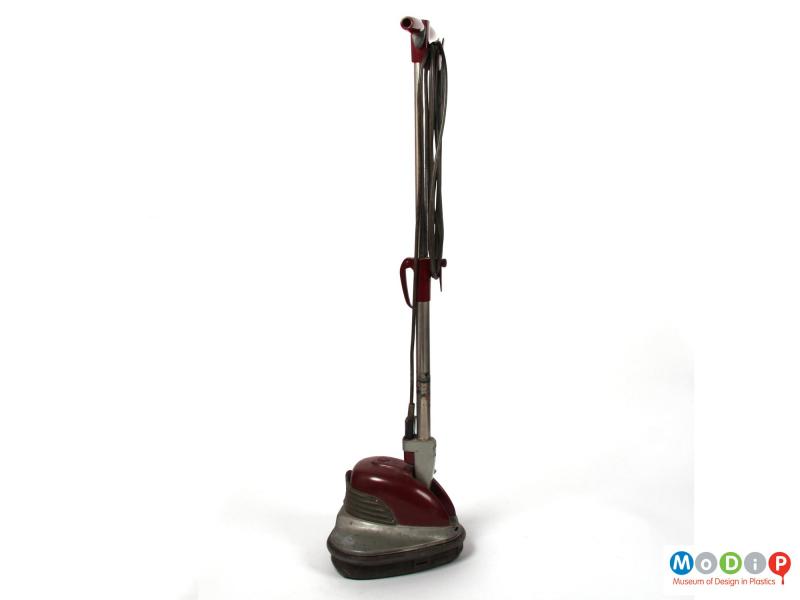 Side view of an Electrolux floor polisher showing how the handle and base fit together.