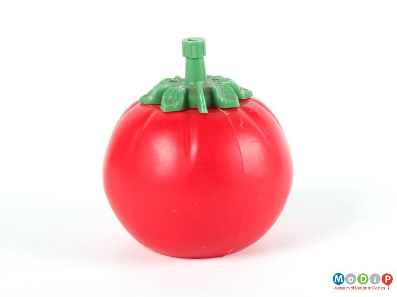 Side view of a tomato sauce bottle showing the round bottle with leaf shaped lid.