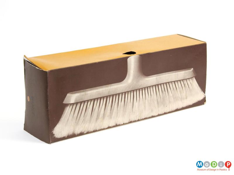 Side view of a broom head showing the packaging.