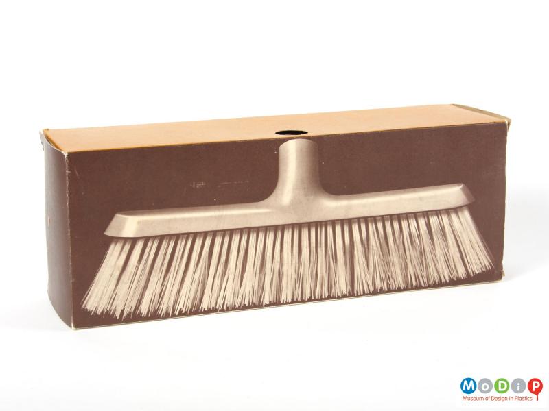 Side view of a broom head showing the original box.