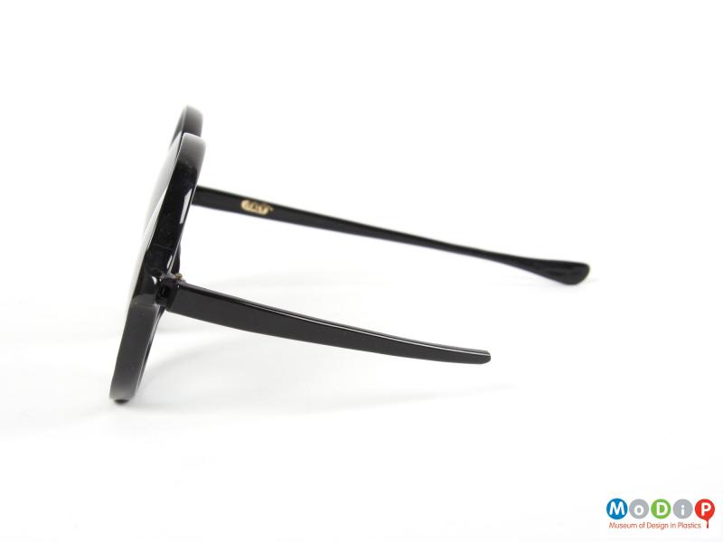 Side view of a pair of sunglasses showing the broken arm.