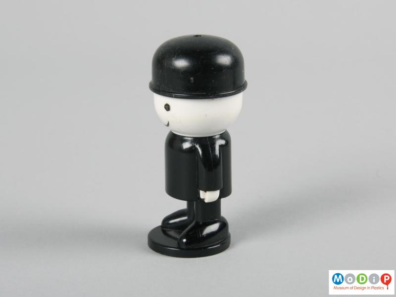 Side view of a salt shaker showing the white hands and face.