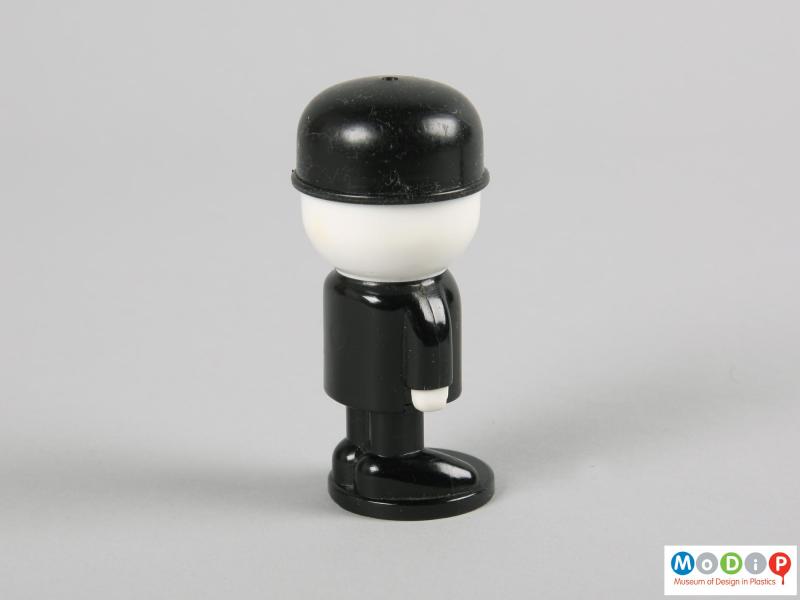 Rear view of a salt shaker showing the black bowler hat and body.