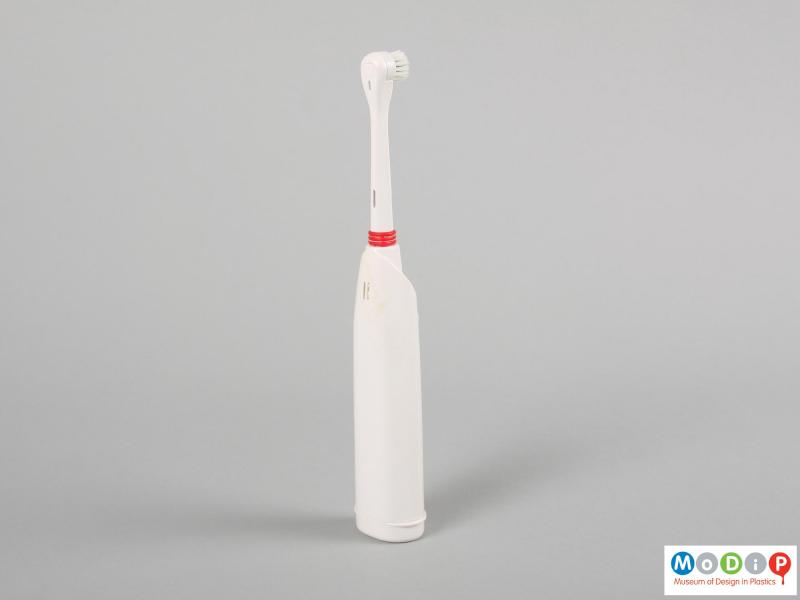Side view of a toothbrush showing the plain back and side.