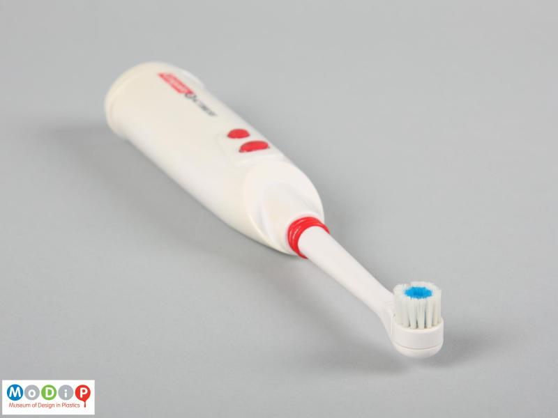 Top view of a toothbrush showing the small, round head.