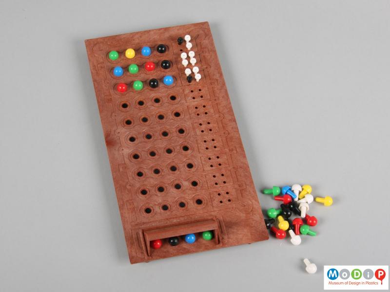 Top view of a Master Mind game showing the board and various pegs.