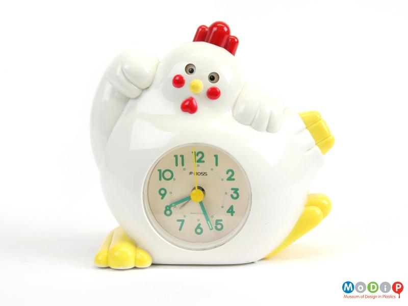 Front view of an alarm clock showing the bird's eyes open.