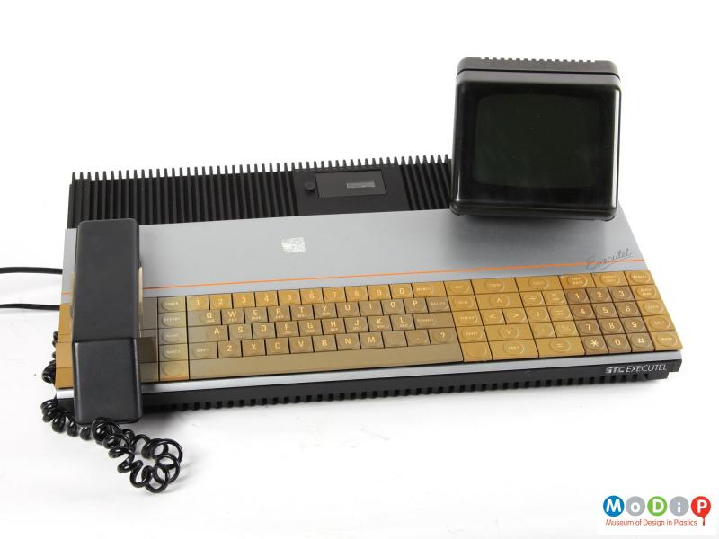 Front view of an Executel unit showing the large keyboard, handset and VDU.