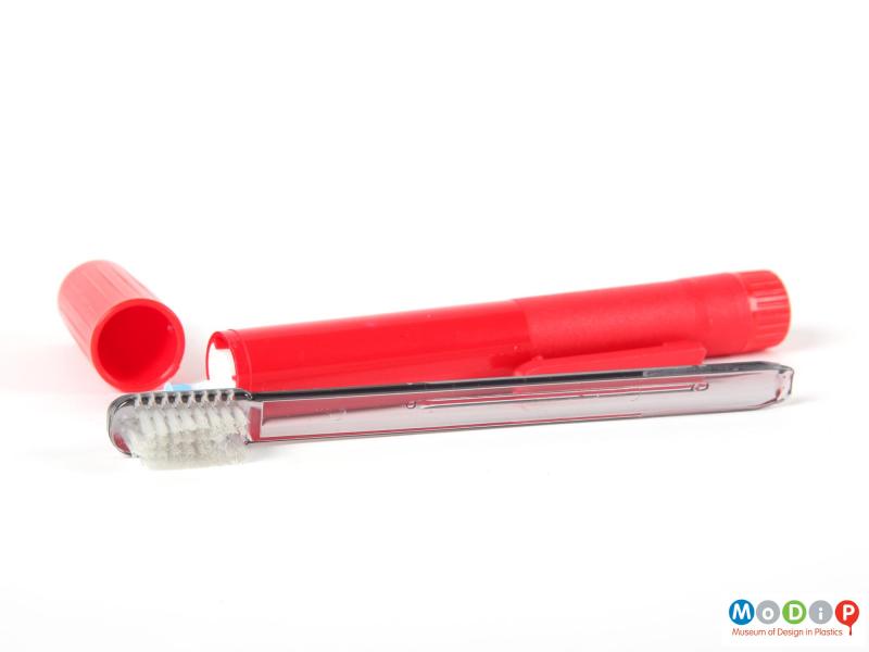 Side view of a Busy Brush showing the toothbrush removed from the holder.