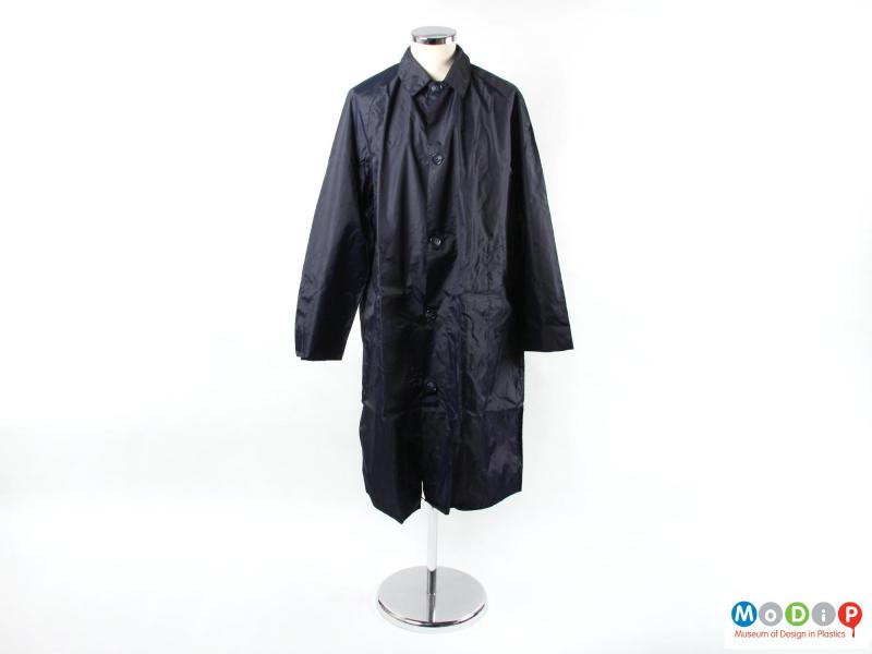 Front view of a rain coat showing the button fastening.