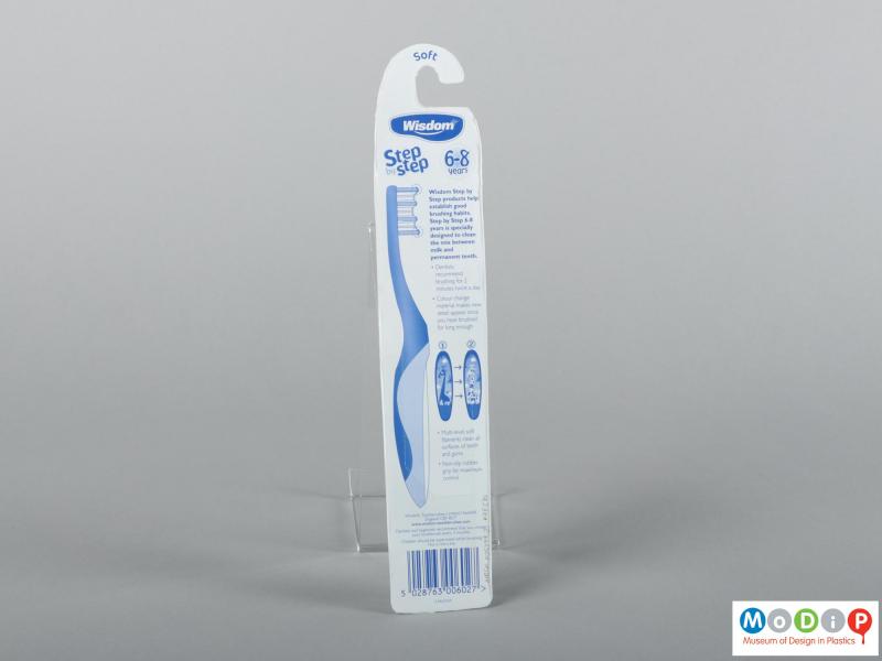 Rear  view of a pair of packaged toothbrushes showing the packaging.