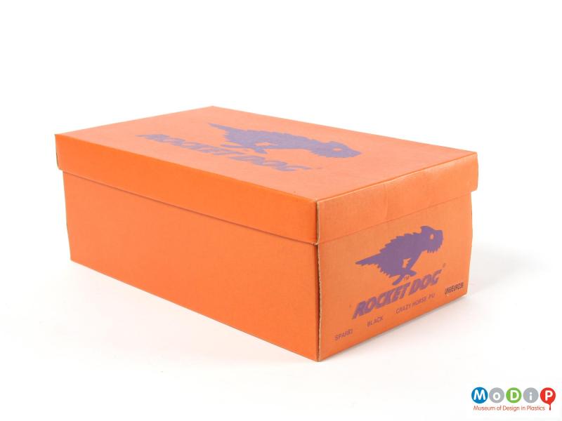 Side view of a pair of shoes showing the packaging.