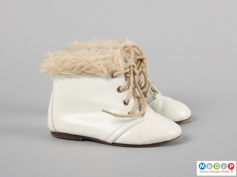 Side view of a pair of boots showing the fake fur trim.