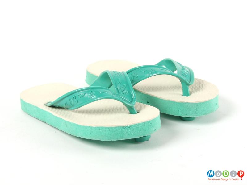Front view of a pair of flip flops showing the foot straps.
