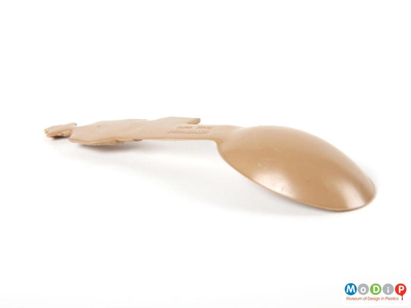 Side view of a Betterware spoon showing the angled bowl.