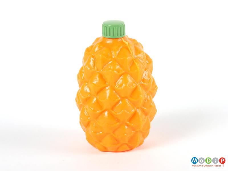 Side view of a pineapple syrup bottle showing the texture moulded into the bottle.