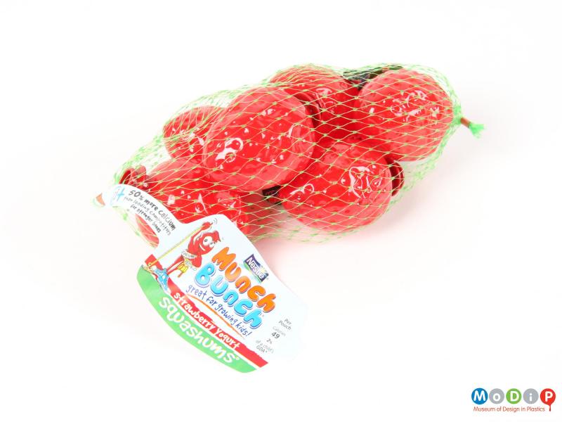 Side view of Squashums packaging showing the strawberry shapes in a net.