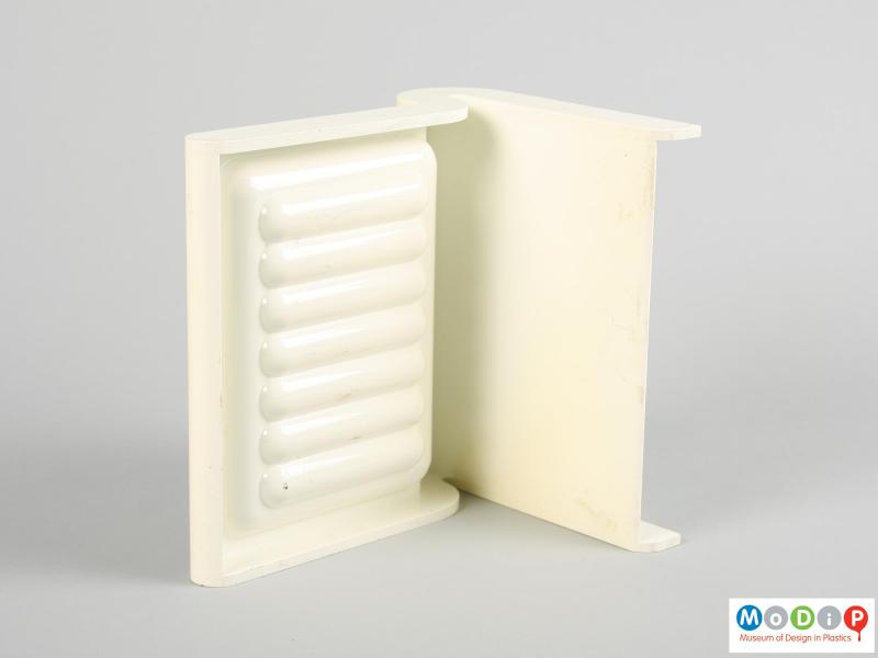 Underside view of a wall mountable soap dish showing the moulded ridged in the tray and plain back plate.