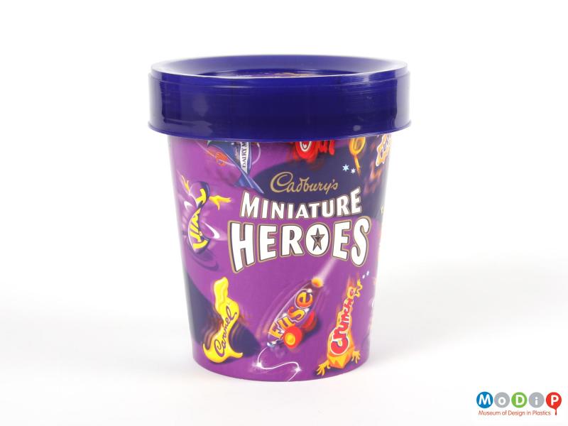 Side view of a Cadbury's Heroes tub showing the printed illustrations.