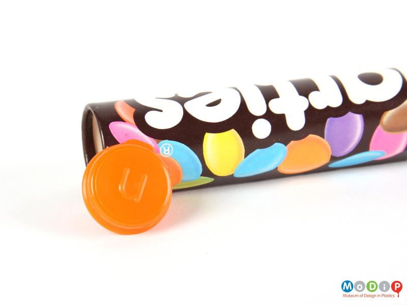 Underside view of a Smarties tube showing the lid.