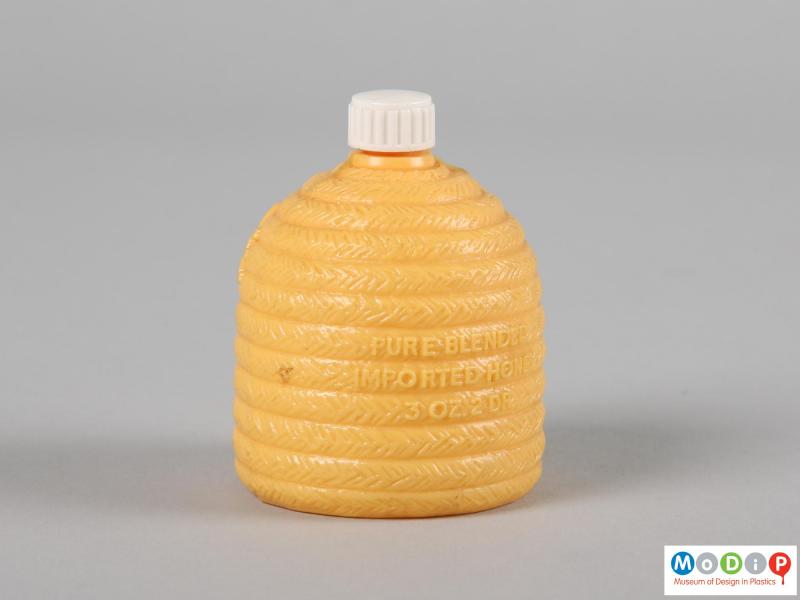 Rear view of a Be Ze Be Honey bottle showing the bee hive shape and the moulded inscription on the back.