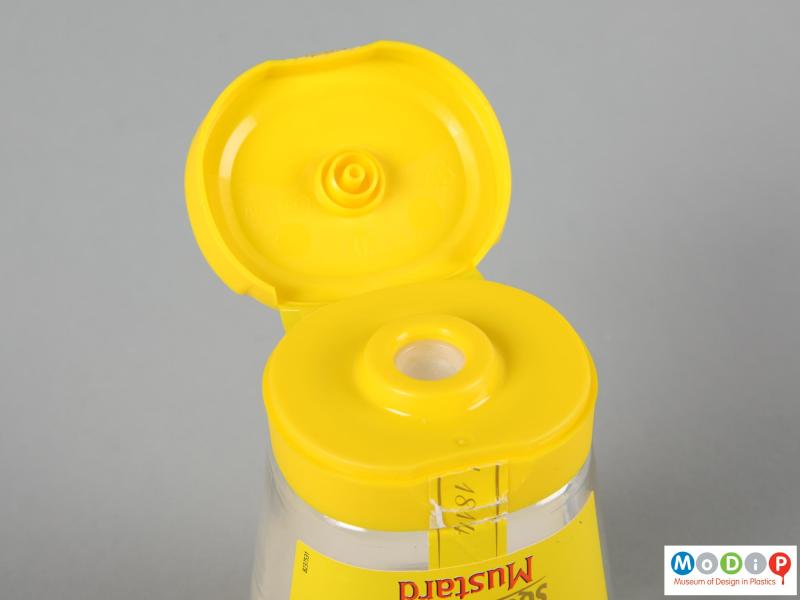 Close view of a Colman's Mustard jar showing the lid open.