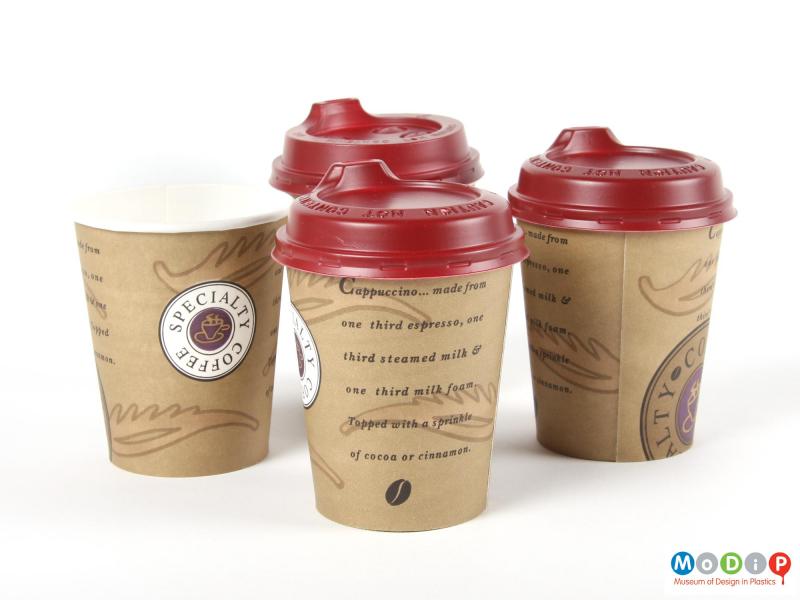 Side view  of three Smart Lids and paper cups showing the two different types of lid.