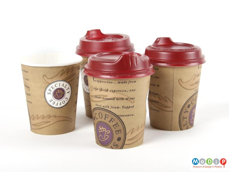 Side view  of three Smart Lids and paper cups showing the two different types of lid.