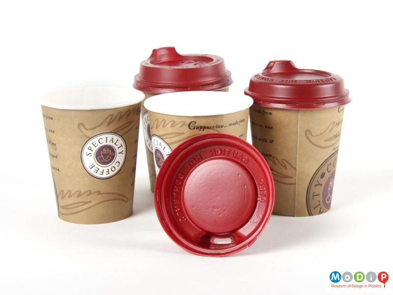 Side view  of three Smart Lids and paper cups showing the inside of one of the lids.
