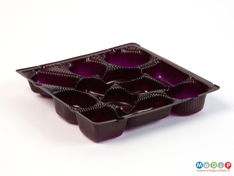 Side view of a chocolate tray showing the moulded spaces for the chocolates.
