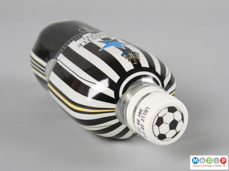 Top view of a football strip bottle showing the football design on the top of the cap.
