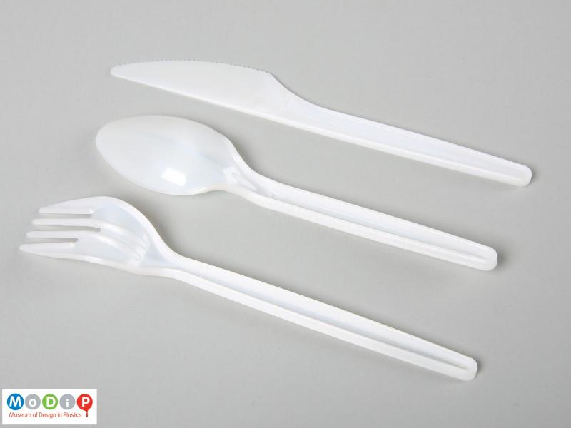 Underside view of a disposable cutlery set showing the straight handles.