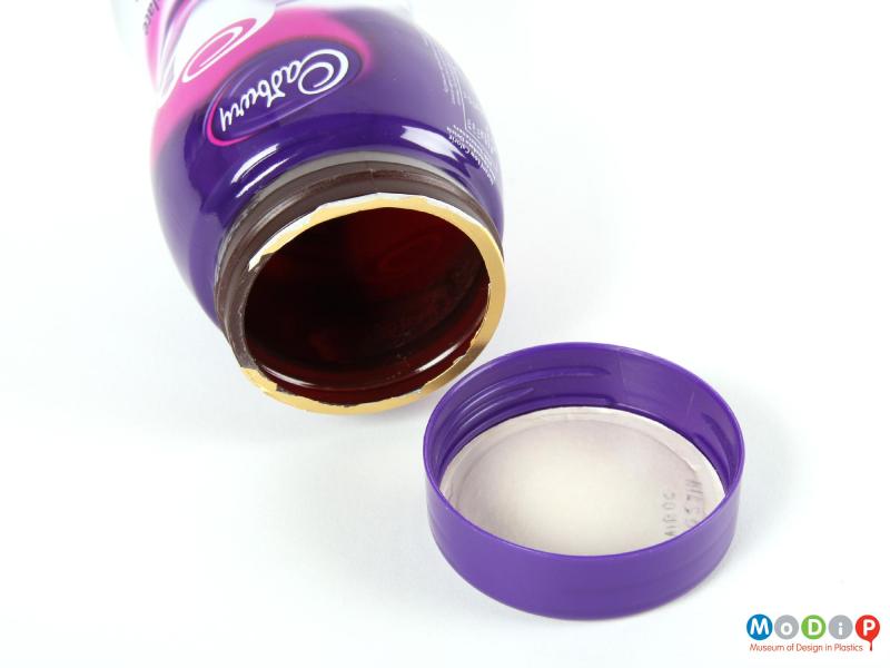 Close view of a Cadbury's Highlights jar showing the screw thread on the neck and the inside surface of the lid.
