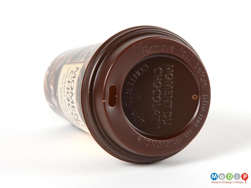 Top view of a Moment Du Chocolat cup showing the moulded inscription on the lid.