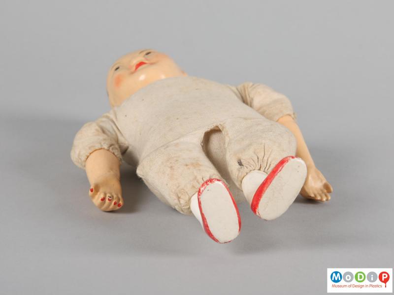Underside view of a doll showing the small flat feet.