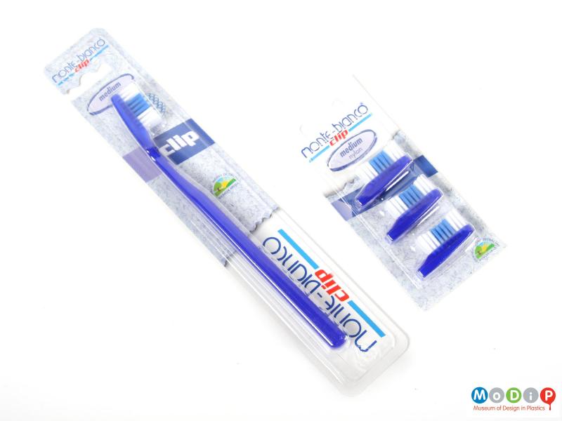 Front view of a toothbrush showing the brush and spare heads in the packaging.