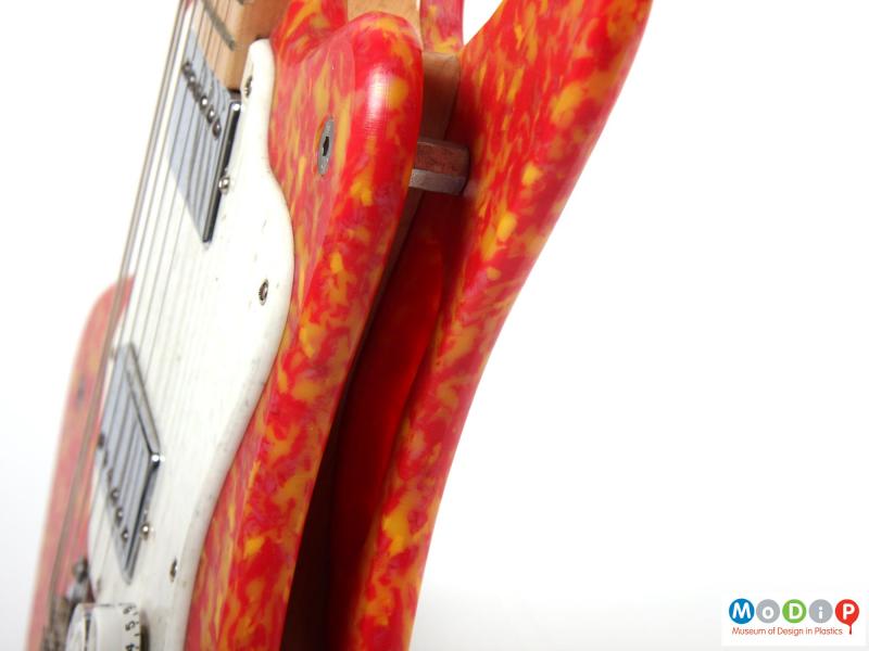 Close view of a guitar showing the front and rear plates.