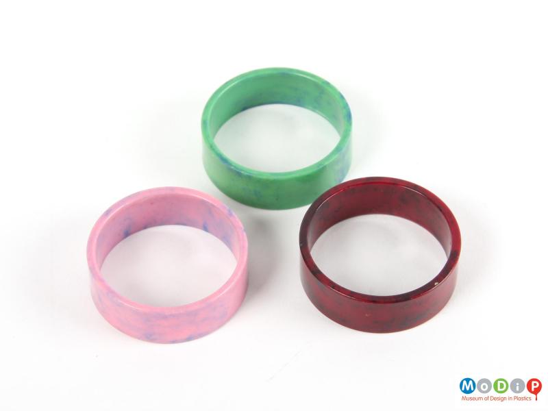 Side view of a set of napkin rings showing the three colours.