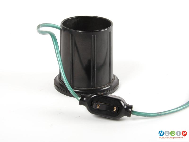 Side view of a bottle warmer showing the control switch.