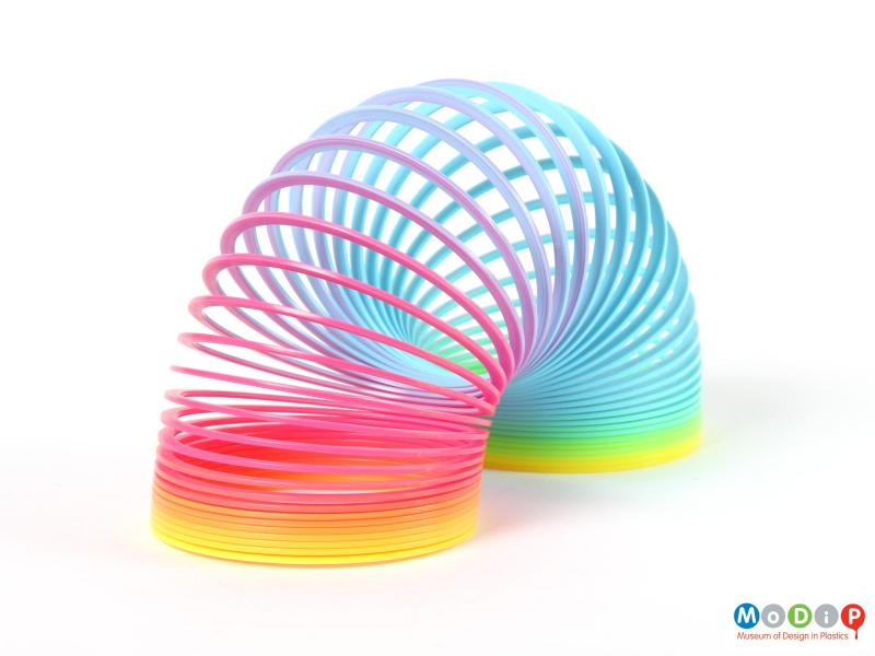 Side view of a plastic Slinky showing it expanded.