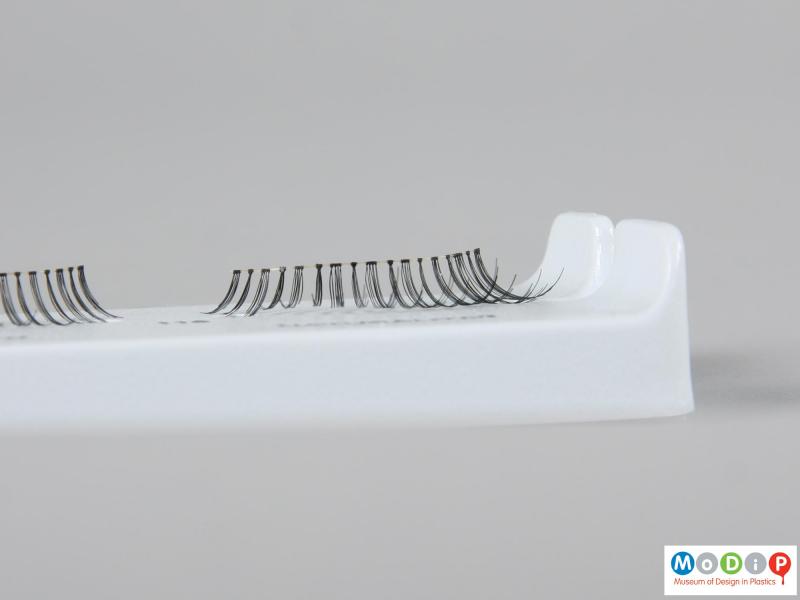 Front view of a pair of false eyelashes showing the different sized groups of lashes.