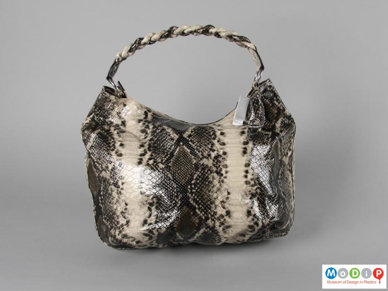 Side view of a handbag showing the snakeskin pattern.