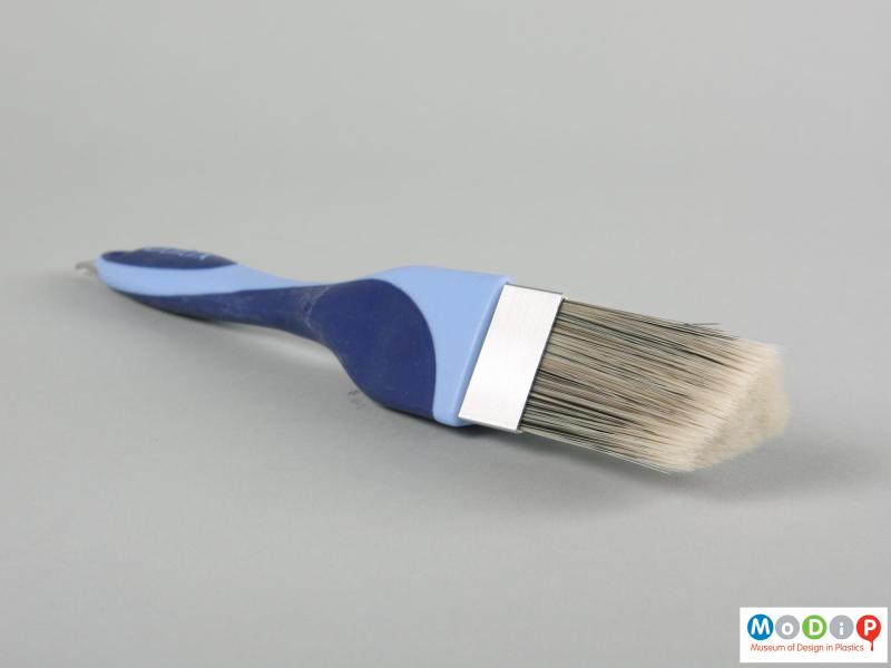 Side view of a paint brush showing the shaped bristles.