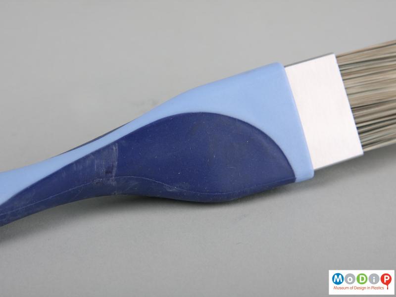 Close view of a paint brush showing the handle material.
