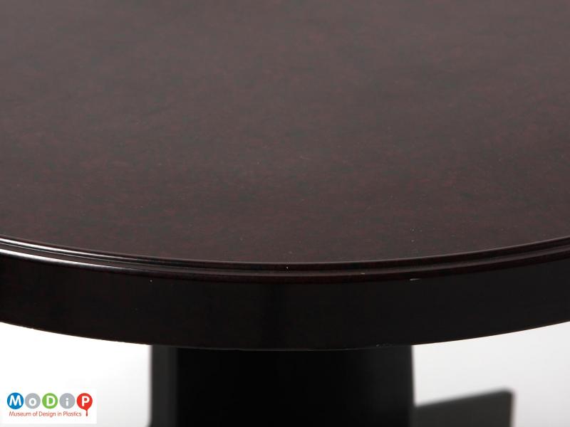 Close view of a table showing the rim around the edge of the top.