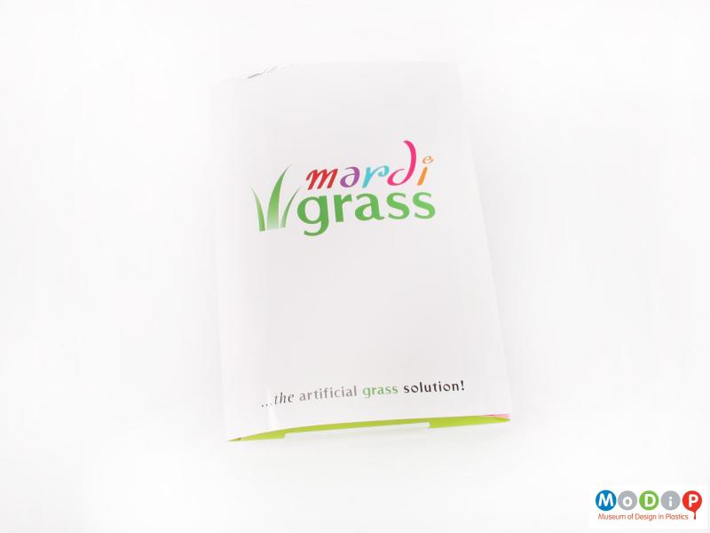 Front view of a grass sample showing the sales brochure.