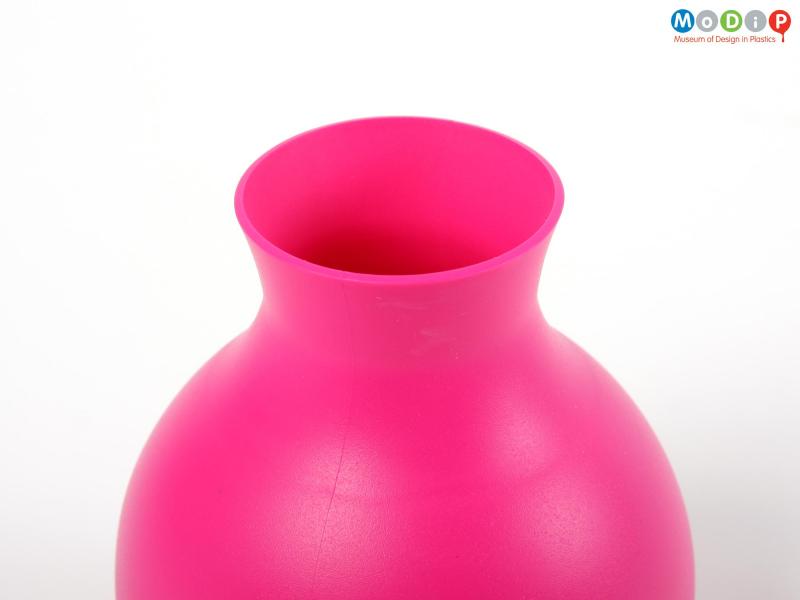 Close view of a Rubber vase showing the neck and mouth.
